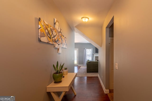 hallway with dark wood-style floors and baseboards