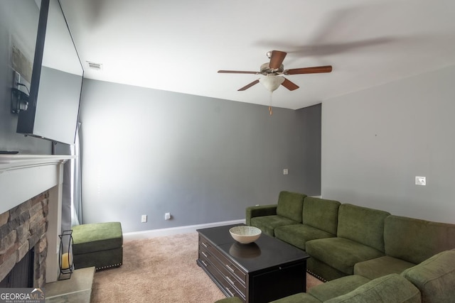 living area with baseboards, visible vents, a ceiling fan, carpet flooring, and a fireplace