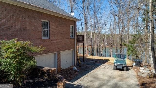 view of property exterior with a garage and brick siding