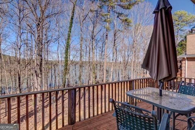 wooden deck featuring outdoor dining area