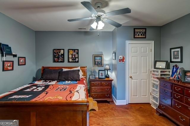 bedroom featuring a ceiling fan, carpet flooring, and visible vents