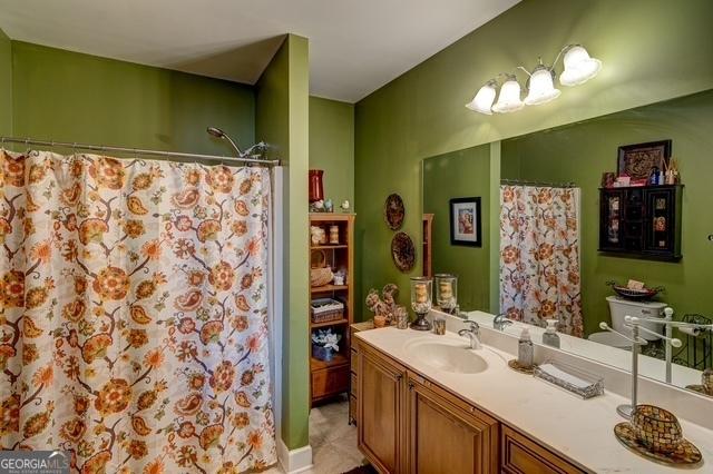 full bathroom with vanity and a shower with curtain