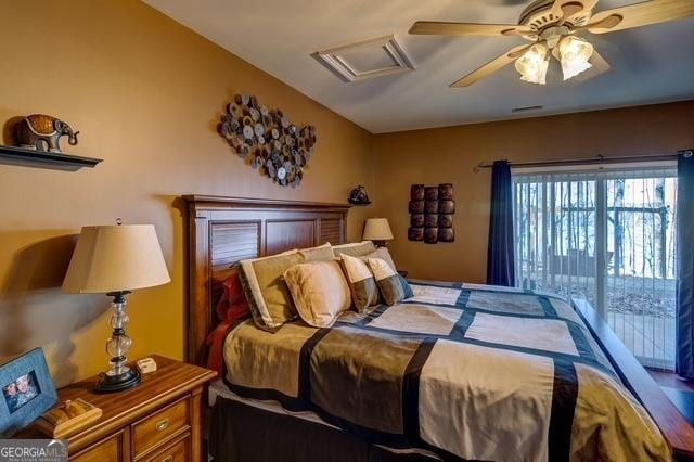 bedroom featuring attic access, visible vents, and ceiling fan