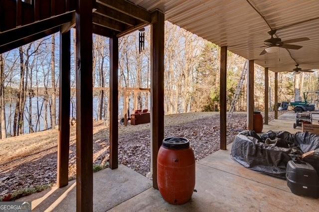 view of patio / terrace featuring a water view and ceiling fan