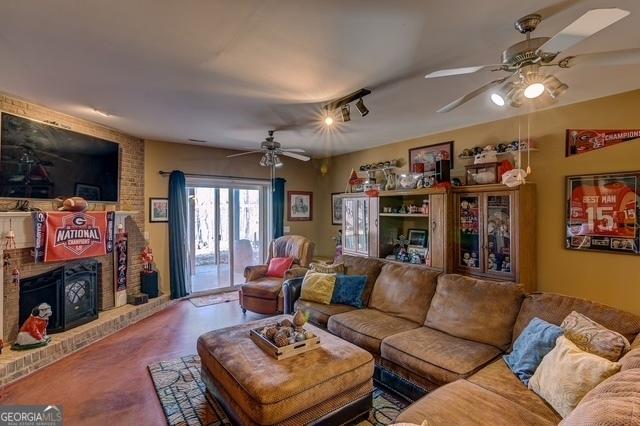 living area featuring a ceiling fan