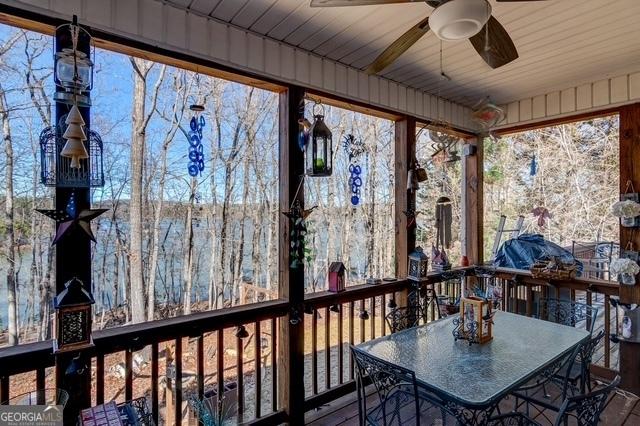 unfurnished sunroom featuring ceiling fan