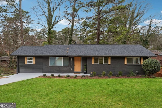 ranch-style home with a shingled roof, brick siding, driveway, and a front lawn