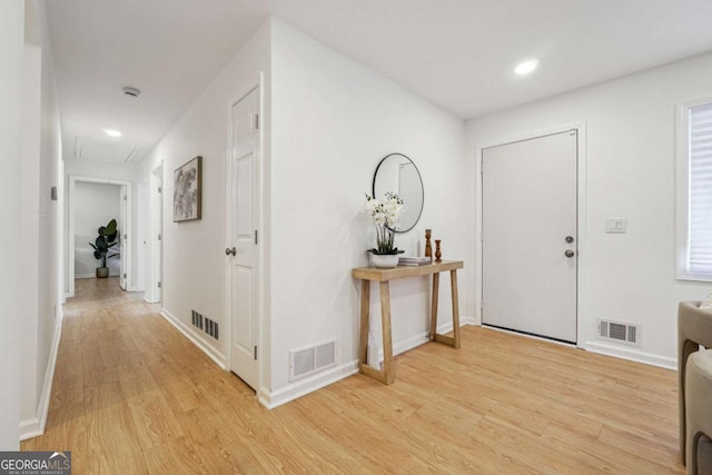 entrance foyer with light wood-style flooring, visible vents, and baseboards