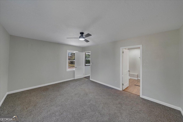 unfurnished bedroom featuring carpet flooring, ceiling fan, a textured ceiling, and baseboards