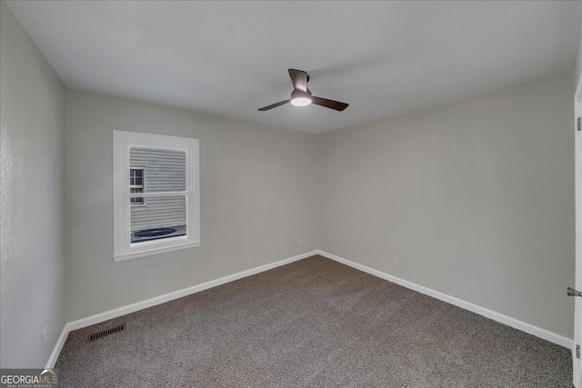 unfurnished room featuring ceiling fan, dark colored carpet, visible vents, and baseboards