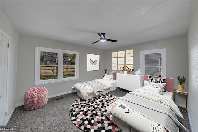 carpeted bedroom with visible vents, ceiling fan, and baseboards