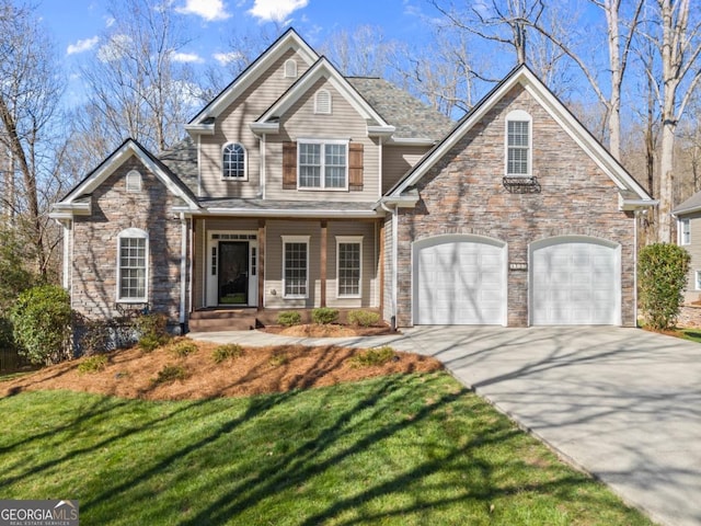 craftsman-style house with concrete driveway and a front yard