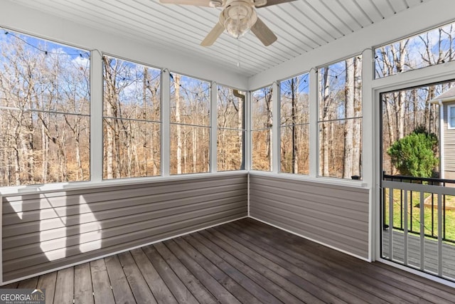 unfurnished sunroom featuring ceiling fan