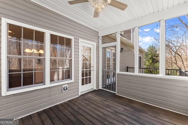 unfurnished sunroom with a ceiling fan