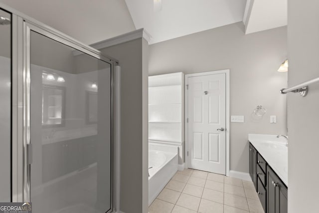 bathroom with baseboards, tile patterned floors, a garden tub, vanity, and a shower stall