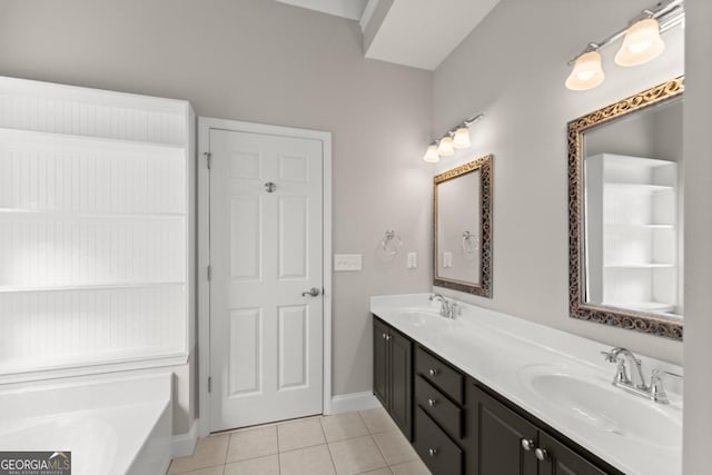 full bath featuring baseboards, double vanity, a sink, and tile patterned floors