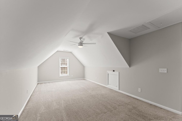 bonus room featuring lofted ceiling, carpet flooring, visible vents, baseboards, and a ceiling fan