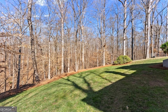 view of yard with a view of trees