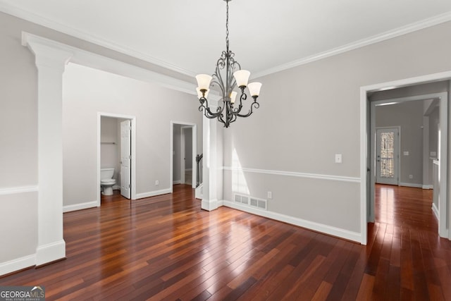 unfurnished dining area featuring hardwood / wood-style flooring, visible vents, baseboards, ornamental molding, and ornate columns