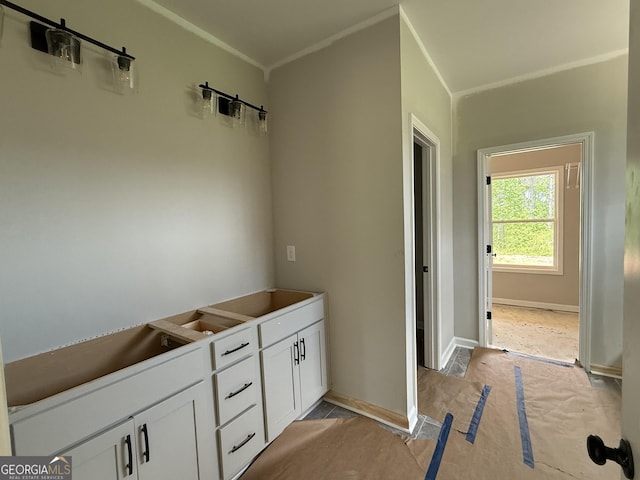 bathroom with crown molding and baseboards