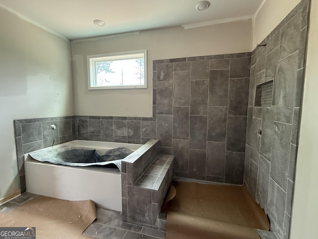 bathroom with tile walls and a bath