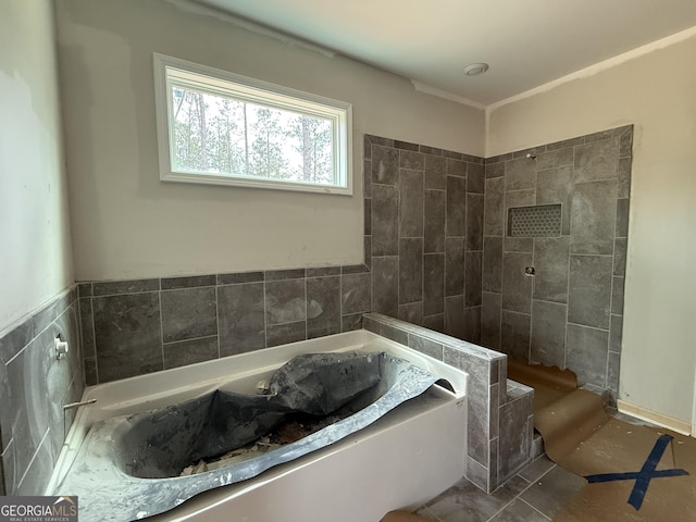 full bath featuring tile walls, a garden tub, and a tile shower