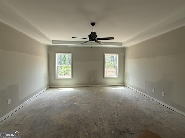 empty room featuring baseboards, a wealth of natural light, and ceiling fan