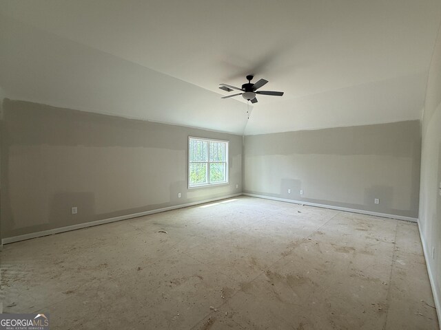 spare room featuring vaulted ceiling, ceiling fan, and baseboards