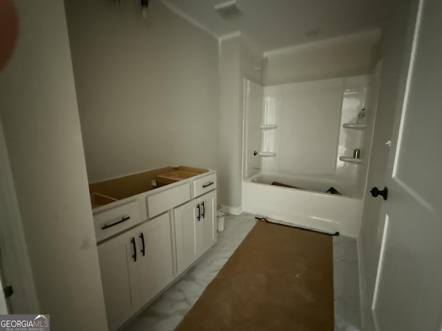 full bathroom featuring marble finish floor, vanity, and shower / bathtub combination