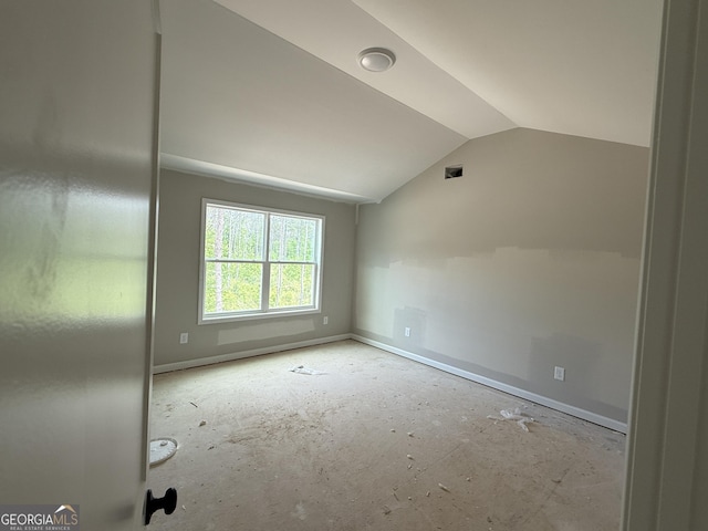 spare room with lofted ceiling and baseboards