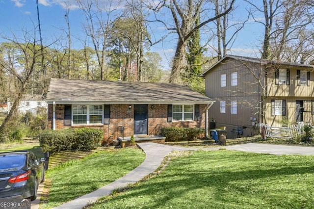 view of front of house with a front lawn and brick siding