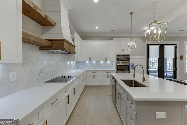 kitchen featuring a sink, open shelves, appliances with stainless steel finishes, white cabinets, and decorative backsplash