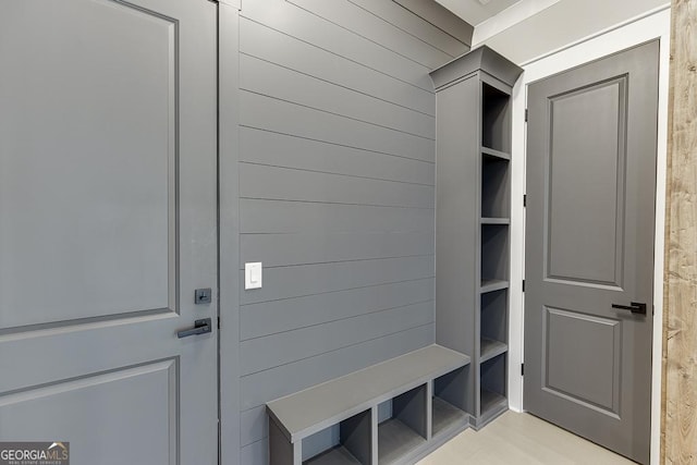 mudroom with wood walls