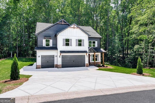 view of front of property with board and batten siding, an attached garage, driveway, and a front yard