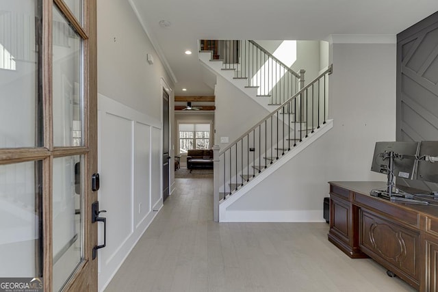 foyer entrance featuring stairway, baseboards, recessed lighting, light wood-style floors, and crown molding