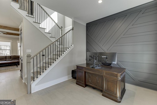 stairway featuring wood finished floors, baseboards, recessed lighting, an accent wall, and crown molding