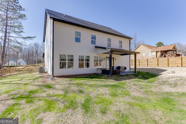 rear view of property featuring a patio area, a fenced backyard, and central AC