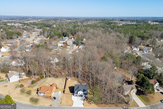 drone / aerial view featuring a wooded view