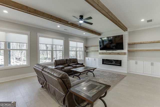 living room featuring visible vents, beam ceiling, a fireplace, light wood finished floors, and baseboards