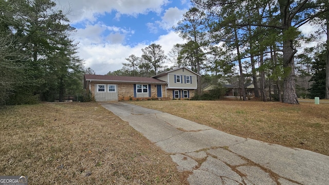 tri-level home with brick siding and a front yard