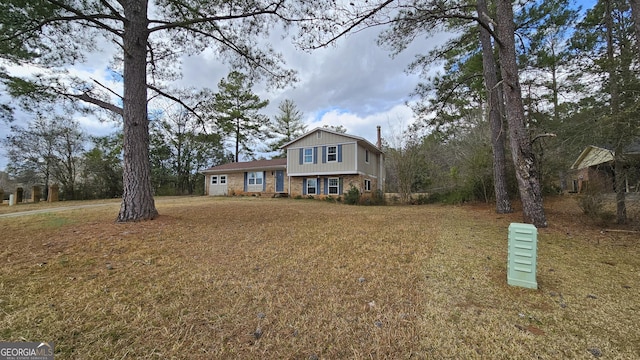 view of front of home with brick siding and a front yard