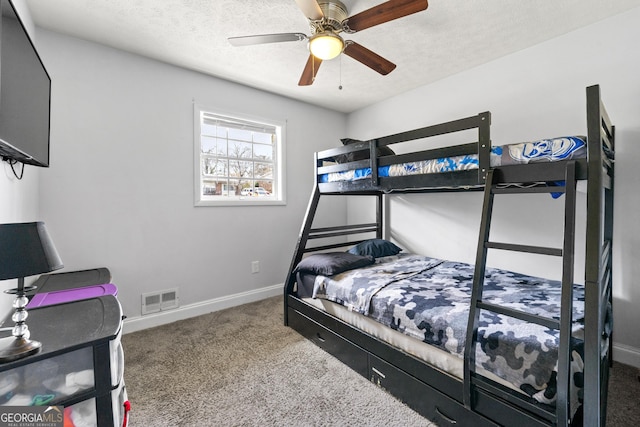 bedroom featuring a textured ceiling, baseboards, carpet, and visible vents