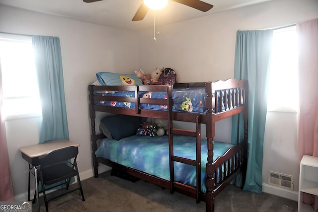 carpeted bedroom with ceiling fan, visible vents, and baseboards