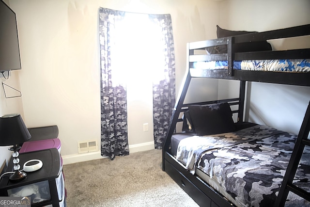 bedroom with carpet, visible vents, and baseboards