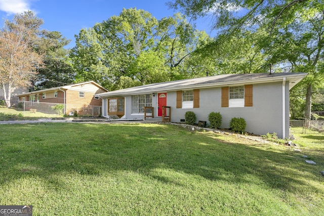 single story home featuring a front yard, fence, and brick siding