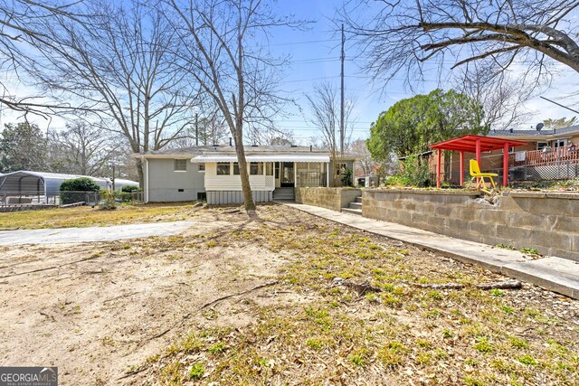 rear view of property featuring crawl space and a carport