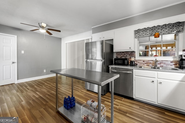 kitchen with white cabinets, a sink, a ceiling fan, and appliances with stainless steel finishes