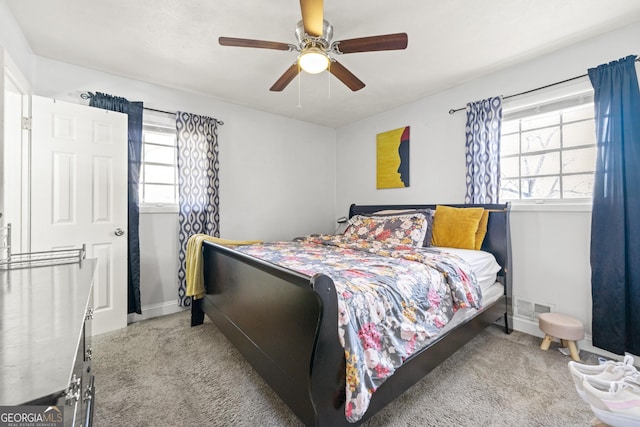 carpeted bedroom featuring ceiling fan, baseboards, and visible vents