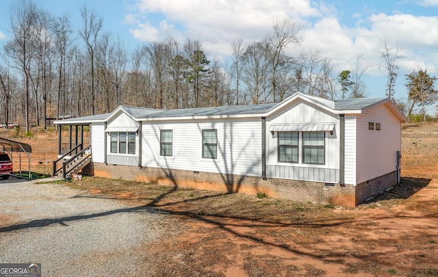 view of front of property featuring metal roof, a carport, and crawl space