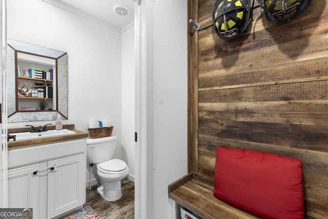 bathroom with vanity, wood finished floors, toilet, and baseboards